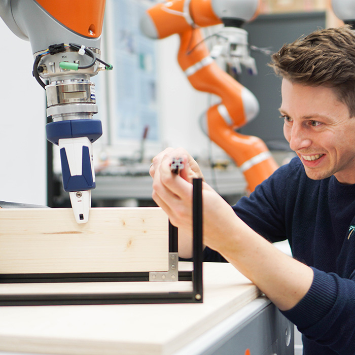 A robotic hand and a human working together