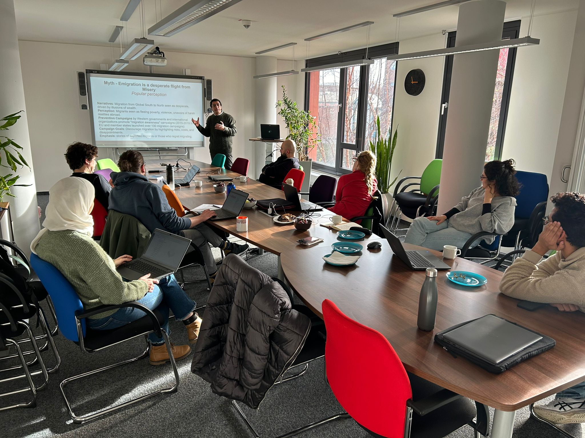 RTG 2951 Researchers sitting around large conference table, listening to Karim Ashour's presentation.