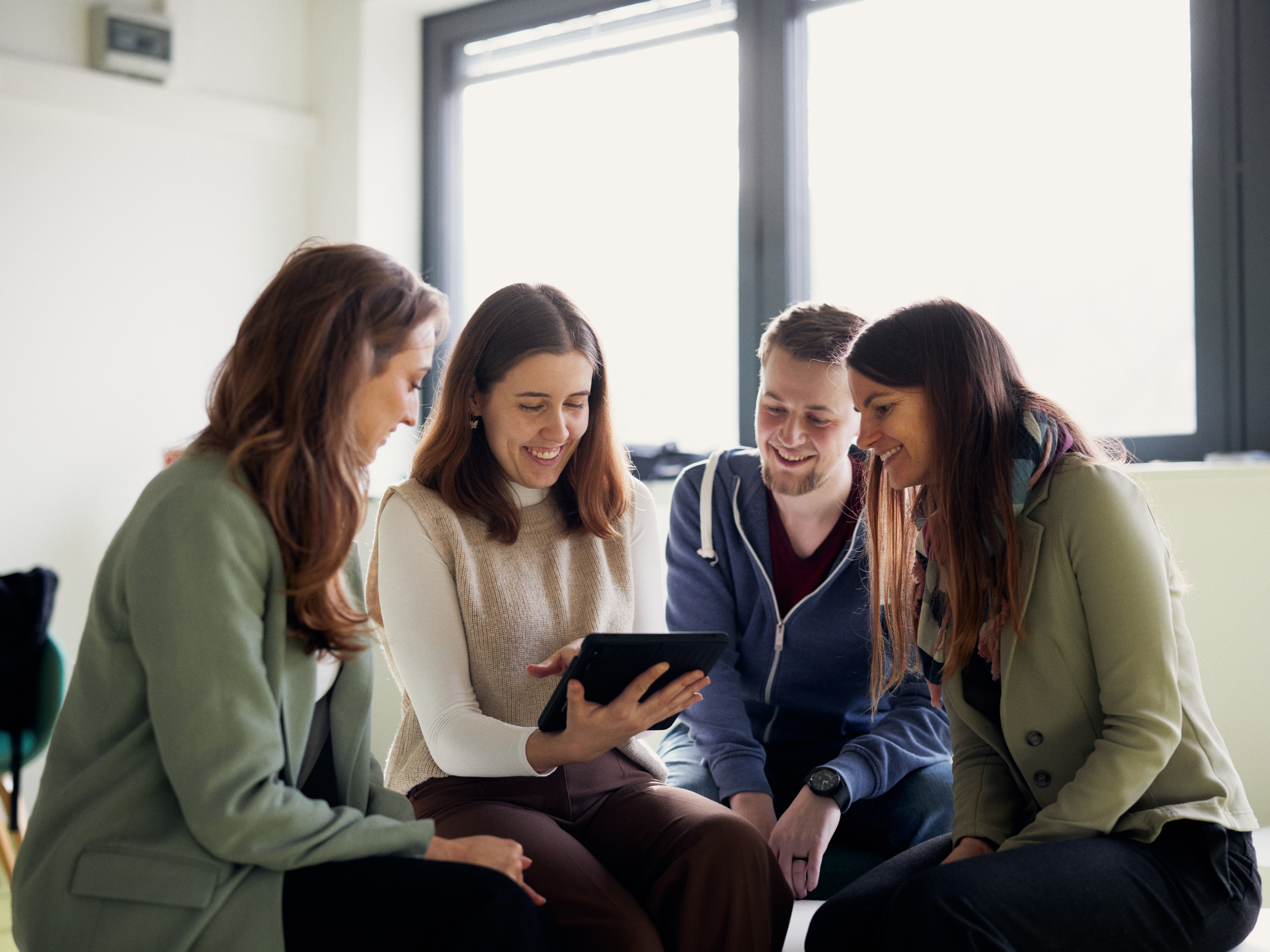 Researchers are discussing something on a tablet